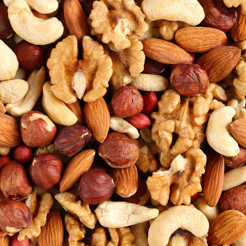 Bulk range of premium nuts in a nut shop. Variety of pistachios, peanuts, kri kri, almonds, macadamias.