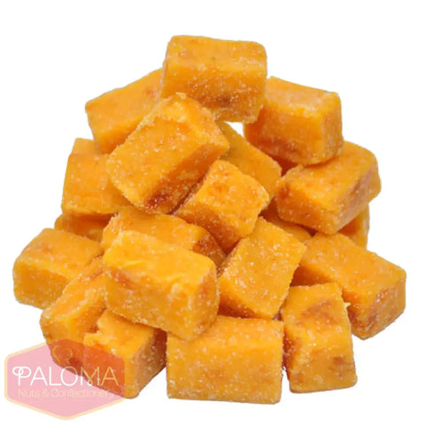 Cubes of orange-colored cheddar cheese stacked together.