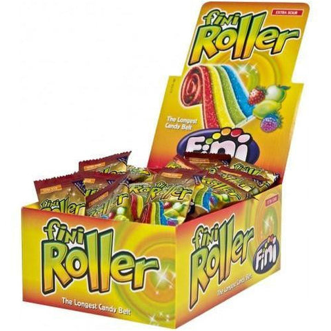 Box of colorful fruit-flavored candy rolls called ’Fini Roller’ with individual wrapped candies displayed inside.