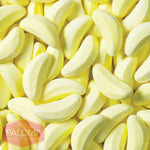 Pile of banana-shaped yellow candy or gummy sweets.