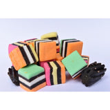 Colorful, layered licorice candy cubes with a piece of black licorice.