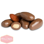 Chocolate-covered almonds with one almond visible and one candy cut in half to show the interior.