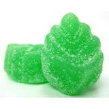 Green, sugar-coated gummy candy shaped like a Christmas tree.