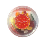 Clear plastic container of colorful candies with a Paloma Nuts & Confectionery label on top.