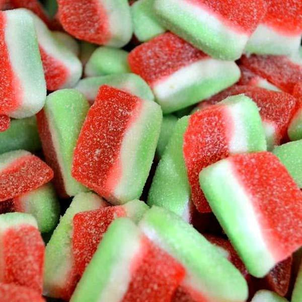 Colorful watermelon-shaped gummy candies with red, white, and green layers.