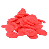 Pile of bright red, disc-shaped candy pieces.