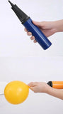 Hand-held balloon pump with a blue body and black nozzle.