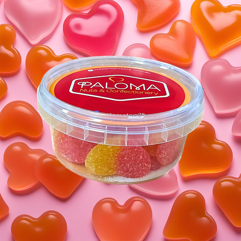 Clear plastic container of Palma brand candies surrounded by heart-shaped gummies.