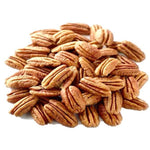 Pile of pecan halves with distinctive ridged surfaces and golden-brown color.